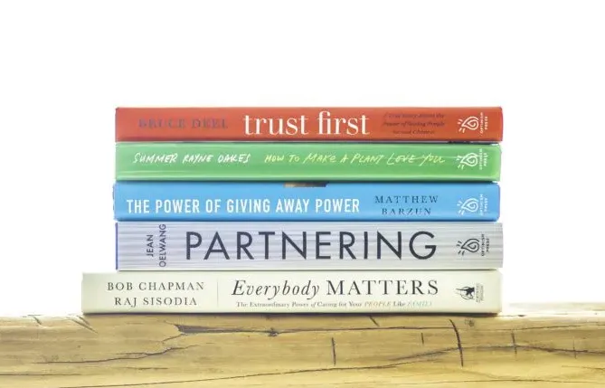 A stack of books published by Optimism Press