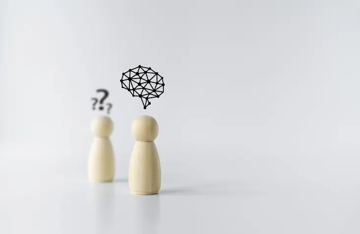 Wooden doll with brain icon. Businessperson or student or leader training skill improvement or development. Business knowledge and education learning success idea. Concept of leadership vision.