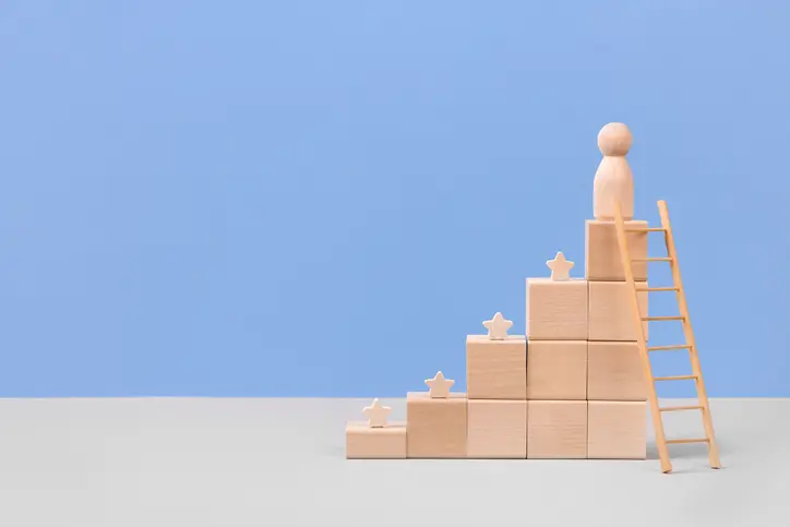 Wooden blocks in form of graphical steps up and wooden stars of business growth process, start-up, business goals management, sustainable financial plan. Action plan, profit, economic improvement concepts