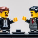 Two lego business people angry at one another