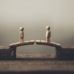 two toy figurines on a bridge